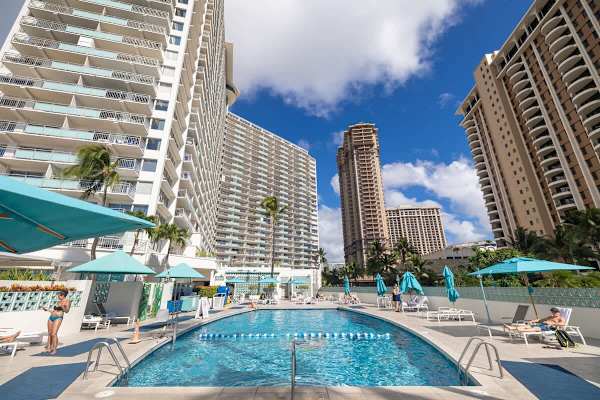 Soak up the sun beside the sparkling, resort-style pool, framed by swaying palms and towering Waikiki skylines for the perfect tropical escape