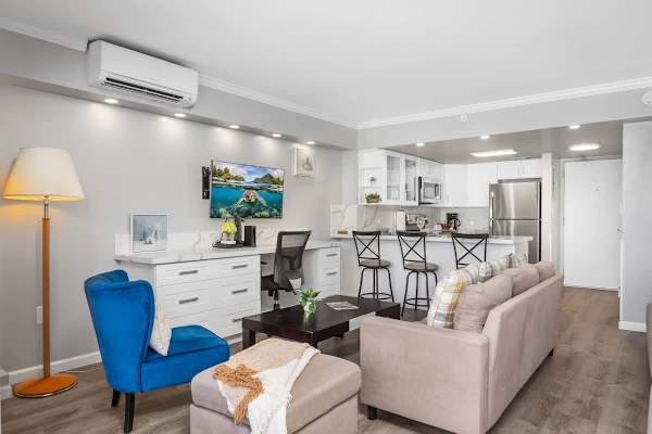 Your living area with a regular sectional sofa, accent chair, coffee table, and a 43'' smart TV.