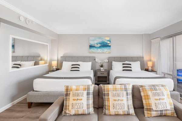 Your condo has 2 queen-size beds, a bedside table and nightstands, a regular sectional sofa, and a wall mirror.
