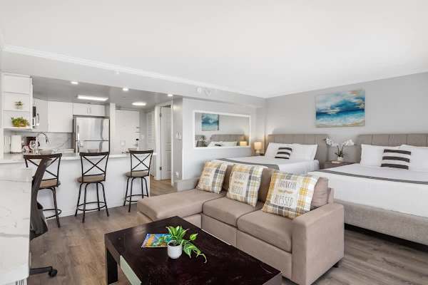 The condo has a regular sectional sofa and a coffee table.