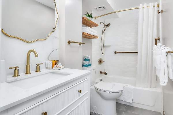A full bathroom with tub and shower combo.
