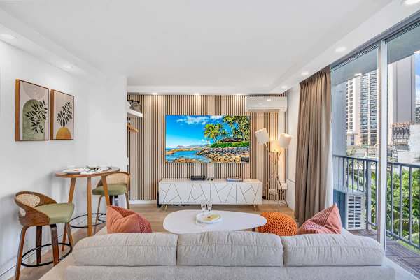 Living area with a new 75'' Samsung Smart TV and a new regular sofa.