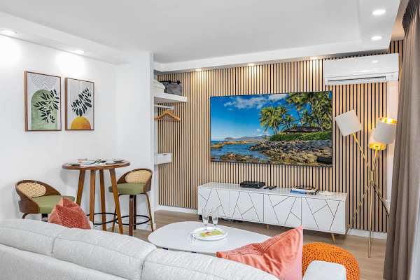 Living area with a new 75'' Samsung Smart TV and a new regular sofa.