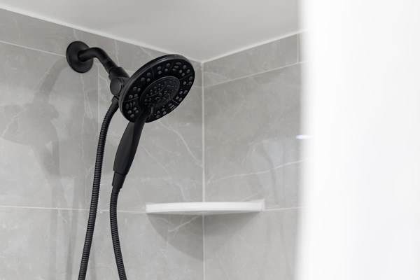 Full bathroom with multifunctional shower.