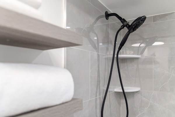 Full bathroom with multifunctional shower.