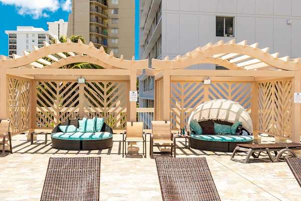 There are 4 daybed cabanas next to the pool