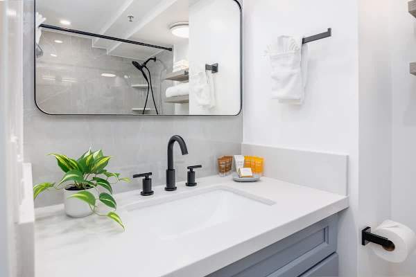 The bathroom has a vanity and cabinet.
