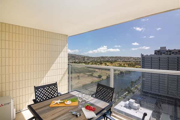 Enjoy your meals on your balcony with a table and 4 chairs and with Ala Wai Canal View and Ocean View on the other side.