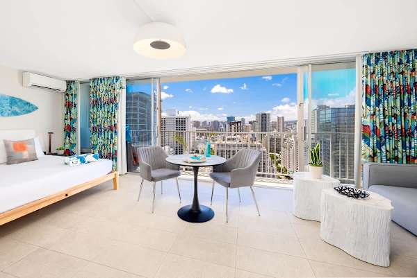 This vibrant studio features a King-size bed, a cozy dining area for 2, and a private balcony offering expansive city views, all adorned with lively tropical decor!