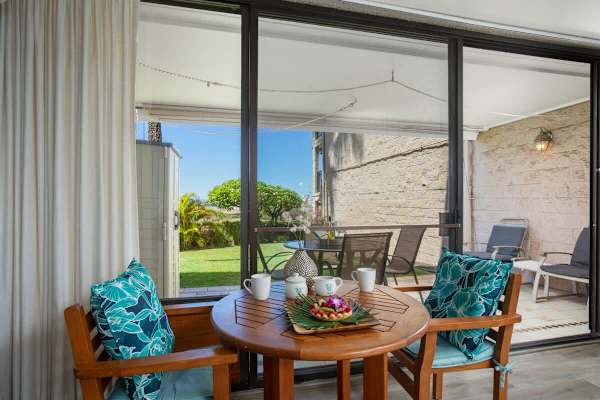 The living area also has a table and chair for dining.