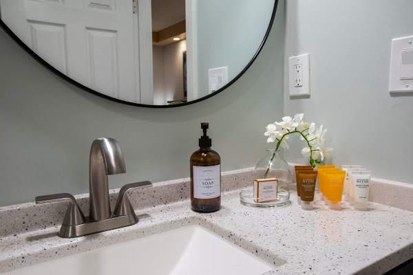 Bathroom with vanity and startup supplies.
