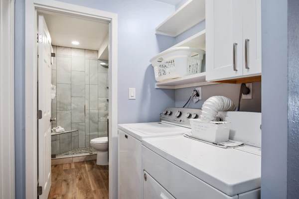 Full bathroom with walk-in shower and own washing machine and dryer.