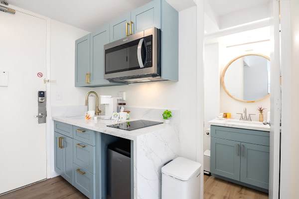 Enjoy the convenience of a contemporary kitchenette, complete with a microwave and cooktop, perfectly complementing the sleek, updated bathroom.