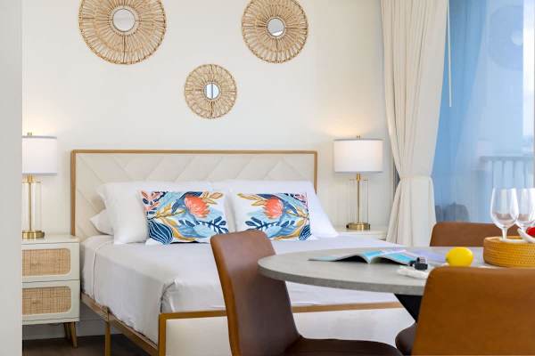 Relax in your chic studio with a plush queen bed, island-inspired décor, and a charming dining area for 4.