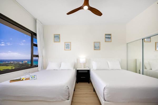 Relax in your bedroom with 2 queen-size beds and 55" Smart TV