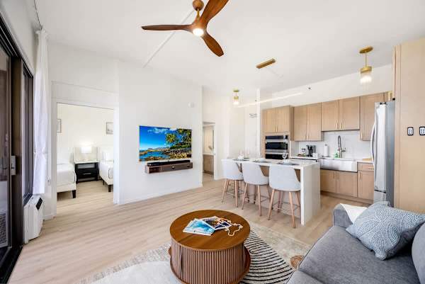Overview of the living room, dining area, and full kitchen