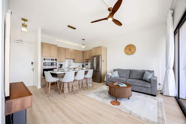 Overview of the living room, dining area, and full kitchen