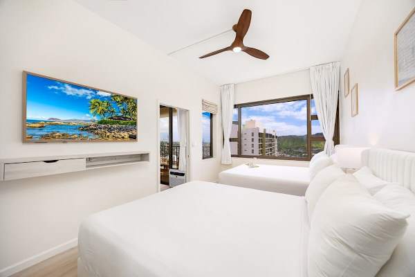 Relax in your bedroom with 2 queen-size beds and 55" Smart TV