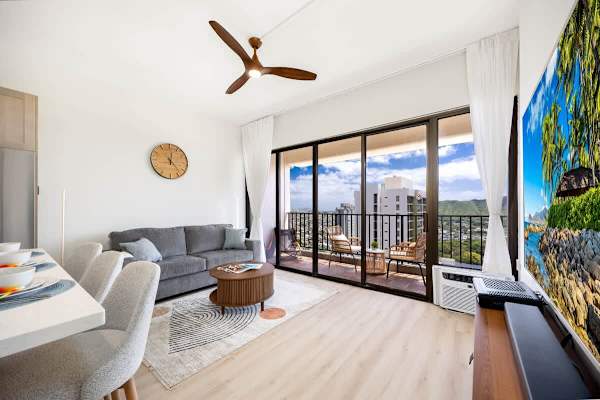Living room with 65" Smart TV, pull-out sleeper sofa, and great views of the ocean and Diamond Head mountains