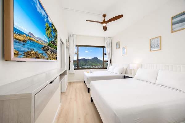 Relax in your bedroom with 2 queen-size beds and 55" Smart TV