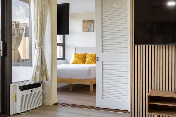 The bedroom is separated from the living room by a sliding door