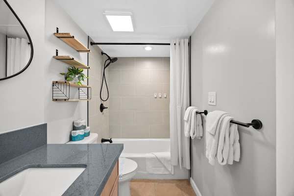 Full bathroom with vanity, and shower & tub combination