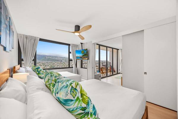 Bedroom with 2 queen-sized beds, TV, and great mountain views from the window