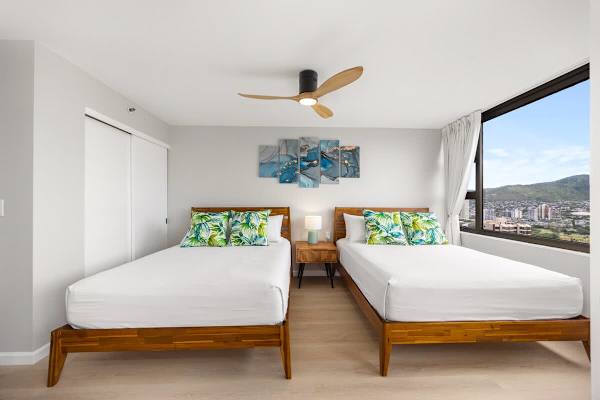 Bedroom with 2 queen-sized beds, TV, and great mountain views from the window