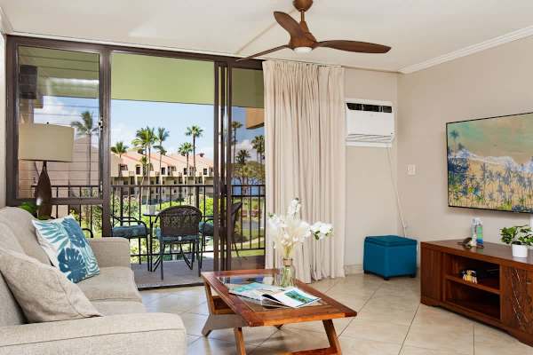 Living room with 65" Smart TV, Pull-out sleeper sofa, Ceiling fan, and Window AC