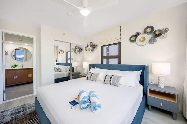 The bedroom has a king-sized bed, ceiling fan, closet, and access to the bathroom