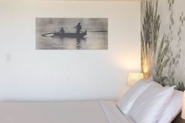 Enjoy restful nights in this queen-size bed plus the soft lighting and a calming, nature-inspired accent wall.