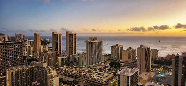 Stunning high-floor view of Waikiki's skyline and ocean at sunset