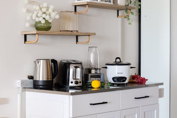 The kitchenette has an electric kettle, toaster, blender, and a rice cooker!