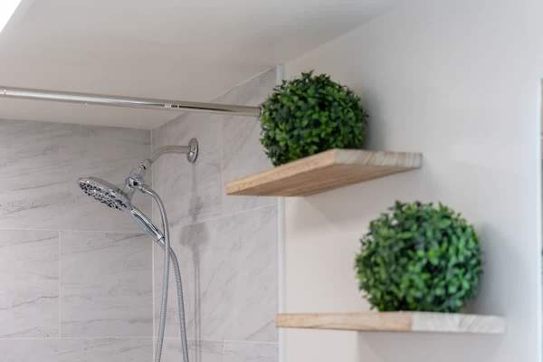 Refresh and revitalize yourself with a delightful shower in this modern bathroom, featuring a versatile showerhead