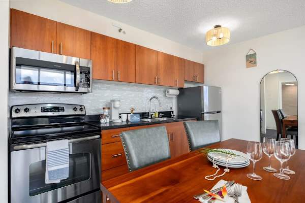 Beautifully appointed kitchen and dining area, featuring modern stainless steel appliances, warm wood cabinetry, and a charming dining setup perfect for entertaining or enjoying a home-cooked meal!