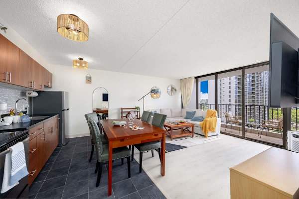 Overview of the full ktichen, dining area, comfortable living space, and beautiful views from the glass window