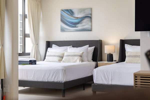 Settle in the bedroom featuring 2 Queen-size beds, stylish decor, and a cozy ambiance, perfect for a restful night