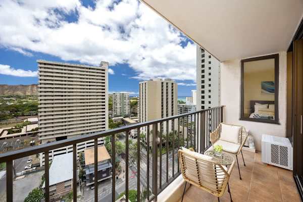Step onto your private balcony and immerse yourself in a vibrant panorama of city life, distant ocean views, and the majestic Diamond Head, all from your comfortable outdoor seating