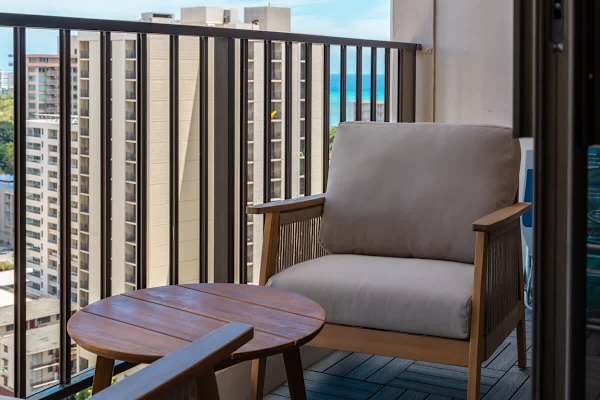 Unwind with a refreshing drink on your private balcony, featuring comfortable seating and charming views of the vibrant city.