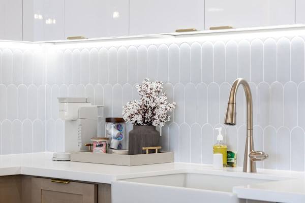 Prepare your favorite beverages in your beautifully designed kitchen, where a convenient Keurig coffee maker and chic details elevate every moment.