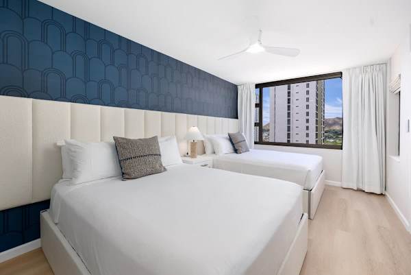 Enjoy peaceful nights in your stylish bedroom, offering two queen beds and refreshing views for a restful escape. 