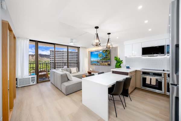 Experience seamless island living in your bright, open-concept Hawaiian retreat, featuring a modern kitchen, comfy living area, and a dedicated dining space with refreshing window AC for your ultimate relaxation.