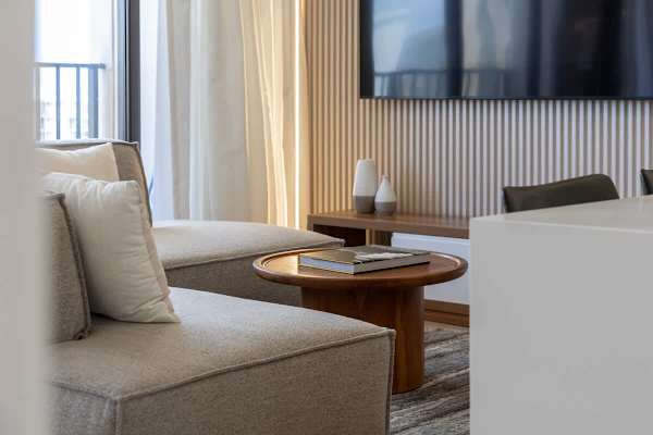 Relax in your modern living room, where the 85" smart TV and sectional sofa create the perfect space for unwinding after a day of island adventures.