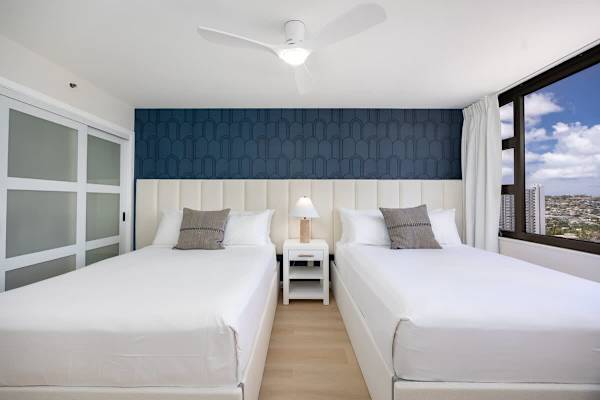 Settle into your cozy bedroom, featuring two queen beds and lovely city and mountain views to start your day!