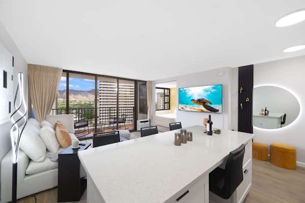 Discover comfort with our sleek kitchen, inviting living room with a sofa and a 65" smart TV, and a private lanai offering captivating views of the mountains and city.
