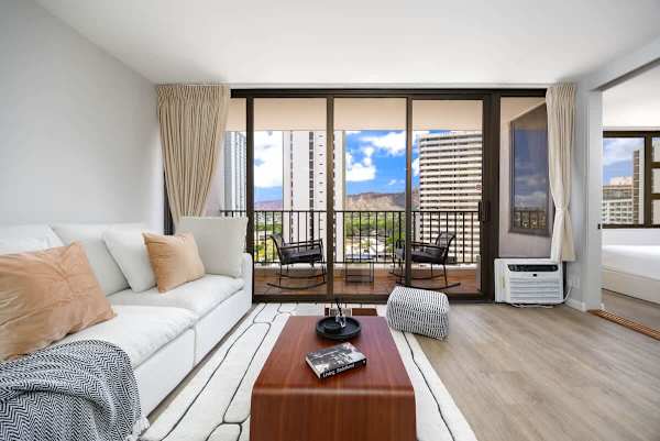 Unwind in a stylish living room that opens directly to your personal lanai, offering a perfect blend of comfort and scenic beauty.