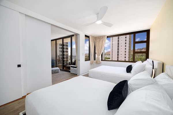 Experience restful nights and bright mornings in a well-appointed bedroom, featuring a queen and a full-size bed, plus stunning natural light and views.