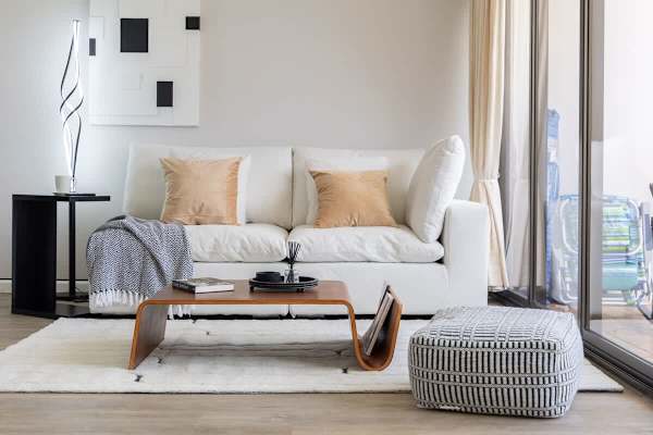 Relax in a chic and comfortable living room, designed for unwinding with stylish decor and ample natural light.