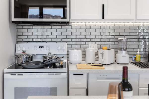 Enjoy the convenience of a well-equipped kitchen featuring a stovetop, oven, microwave, blender, toaster, and all the cooking essentials.