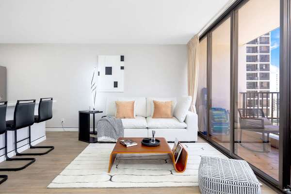 Relax in a chic and comfortable living room, designed for unwinding with stylish decor and ample natural light.